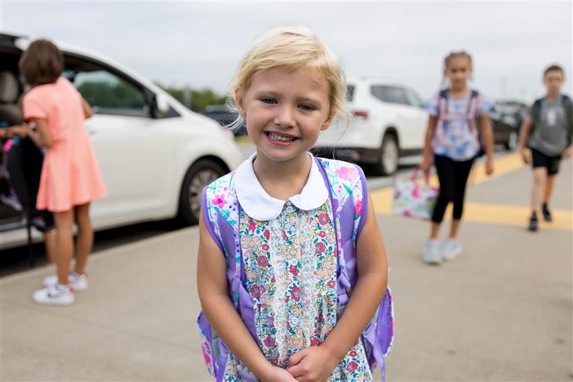 A young student smiles